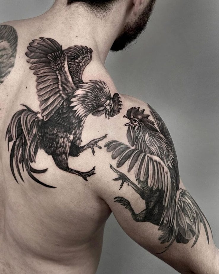 20. A rooster fight tattoo on the back and shoulder