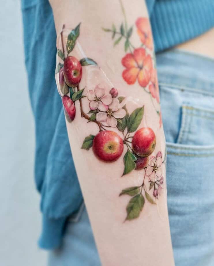 1. A realistic, colorful apple branch tattoo 