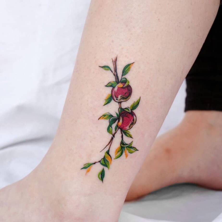 16. An apple branch tattoo above the ankle 