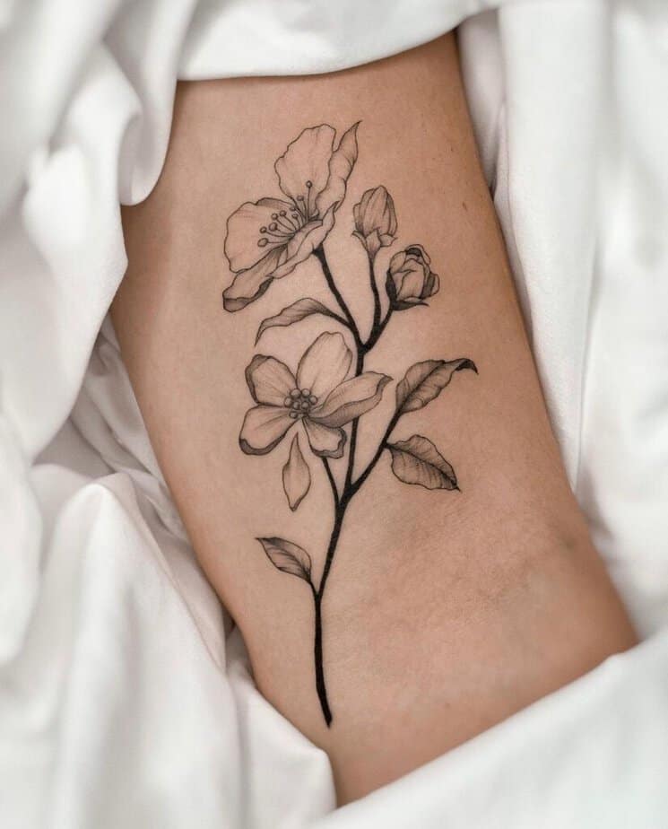4. An apple tree branch tattoo on the arm