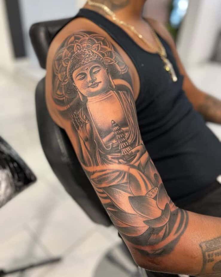 12. A Buddha quarter-sleeve tattoo