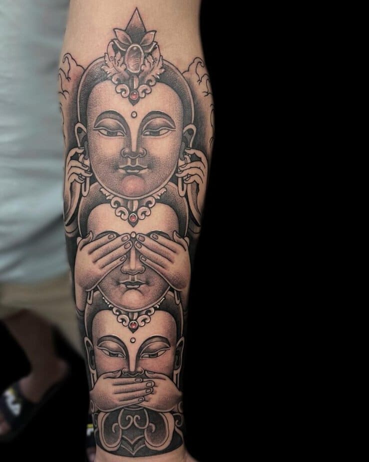 14. A tattoo of three wise Buddhas 