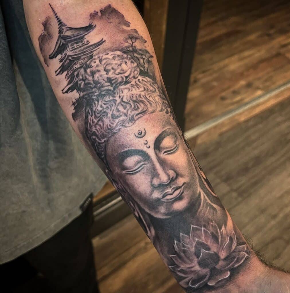 19. A Buddha, lotus flower, and pagoda tattoo