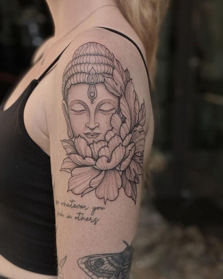 23. A fine-line Buddha tattoo 