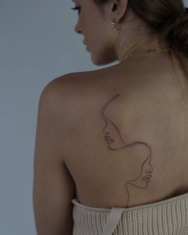 13. A line-art back tattoo
