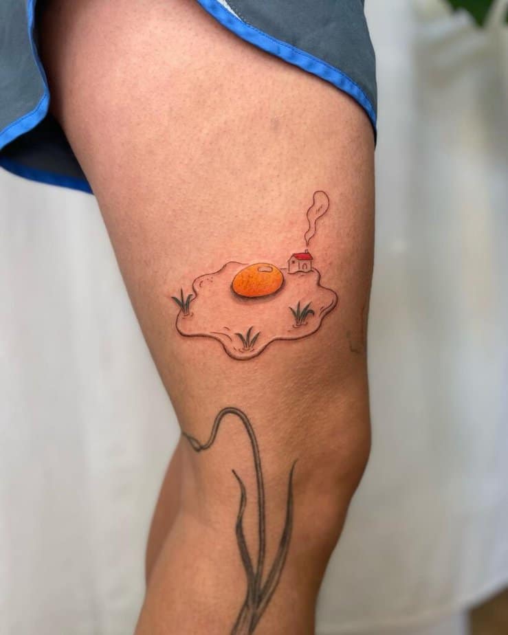 17. A tattoo of an egg with a little house