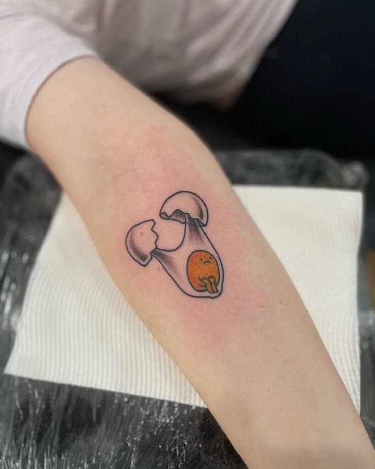 18. A tattoo of a sad egg yolk