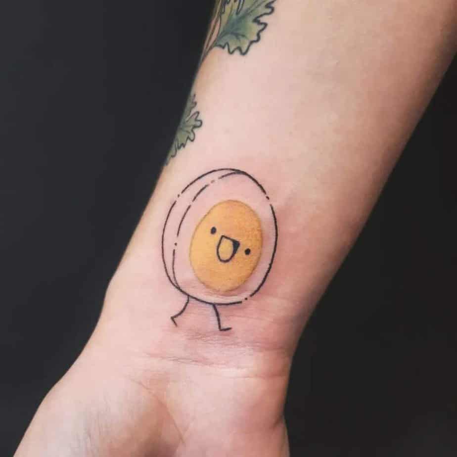 19. A tattoo of a happy egg yolk