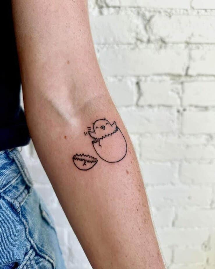 2. A tattoo of a hatched egg on the forearm
