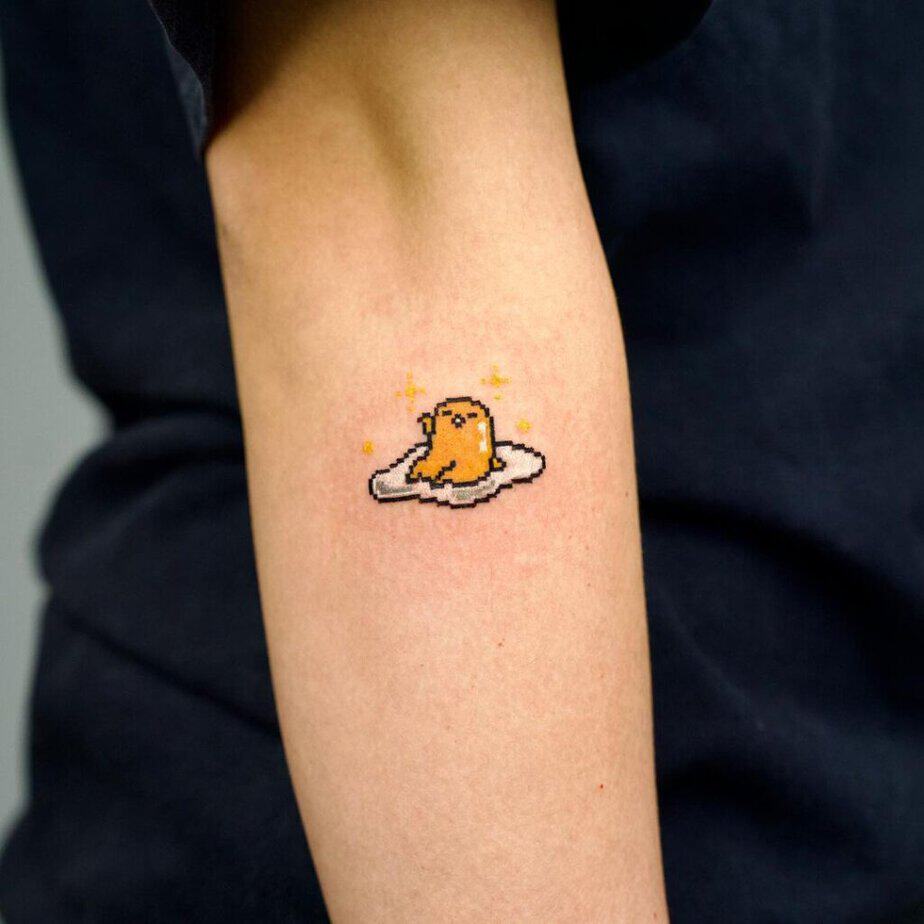 22. A pixelated egg tattoo on the forearm