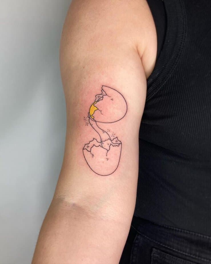 5. A tattoo of a cracked egg on the bicep