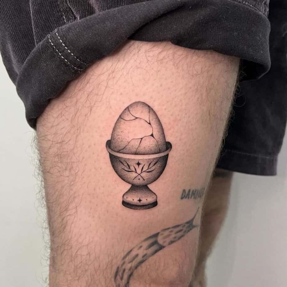 6. A tattoo of a cracked egg on the thigh