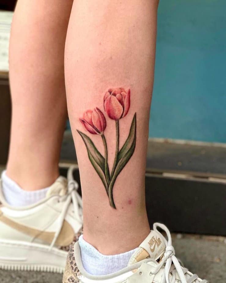 16. A leg tattoo of two tulips 