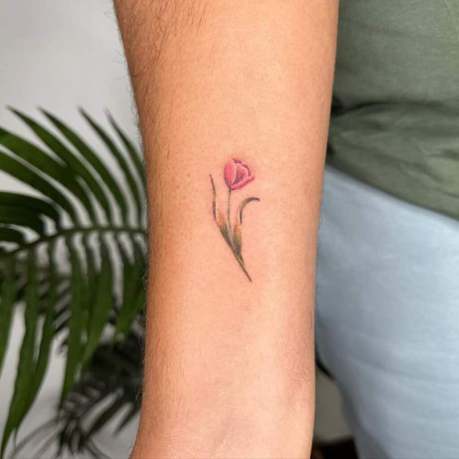 22. A minimalist tattoo of a pink tulip 