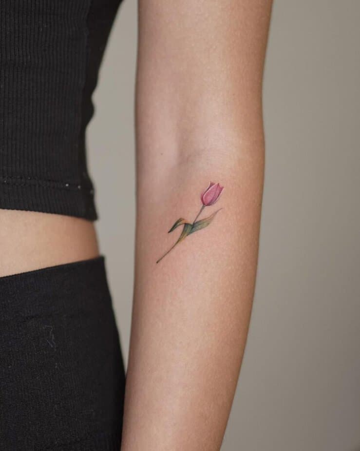 3. A tiny tulip tattoo on the forearm