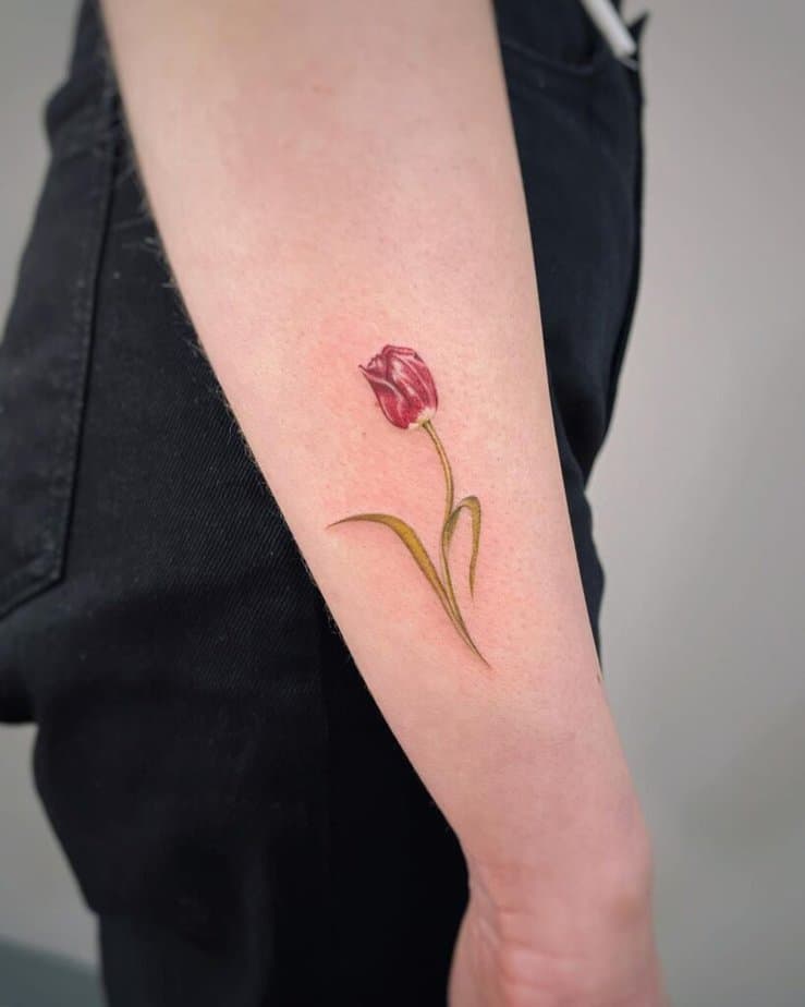 5. Un tatuaggio realistico a tulipano sul lato del braccio