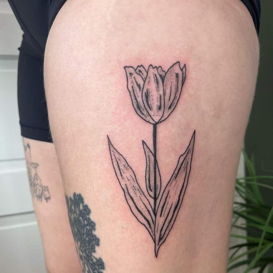 6. A tulip tattoo on the thigh