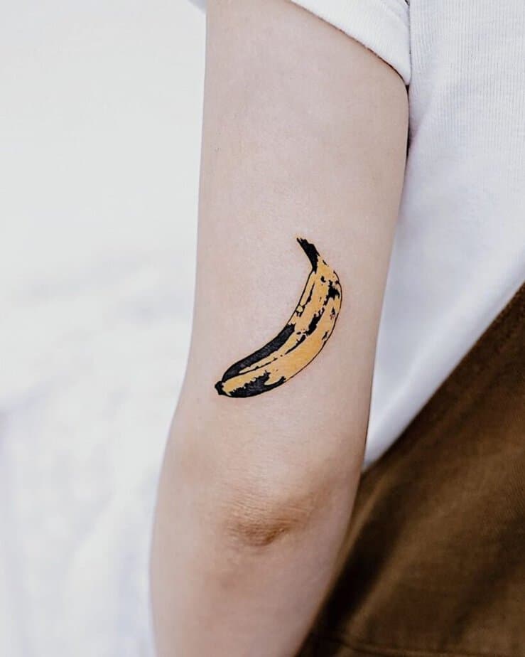 16. A tattoo of a ripe banana on the back of the arm