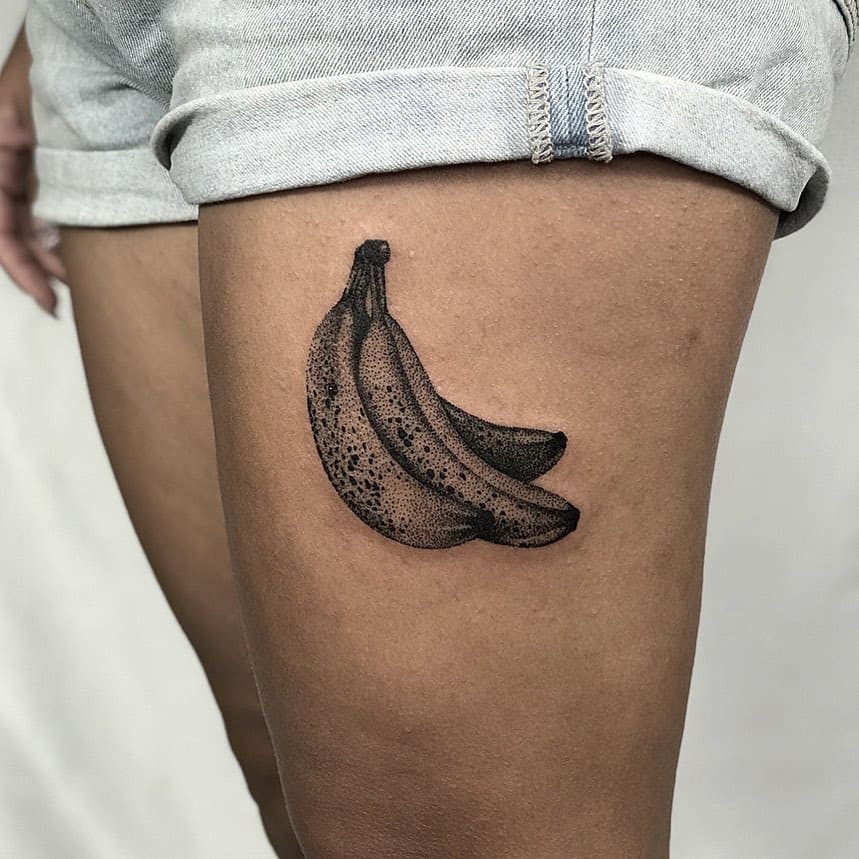 19. A realistic banana tattoo on the thigh