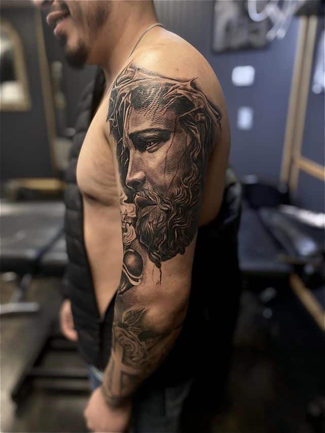 10. Impressive Jesus half-sleeve tattoo