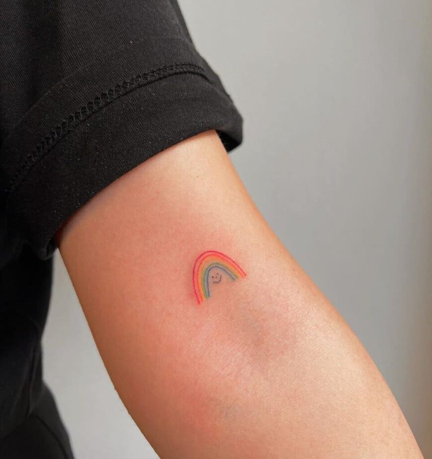 1. A rainbow tattoo with a smiley face