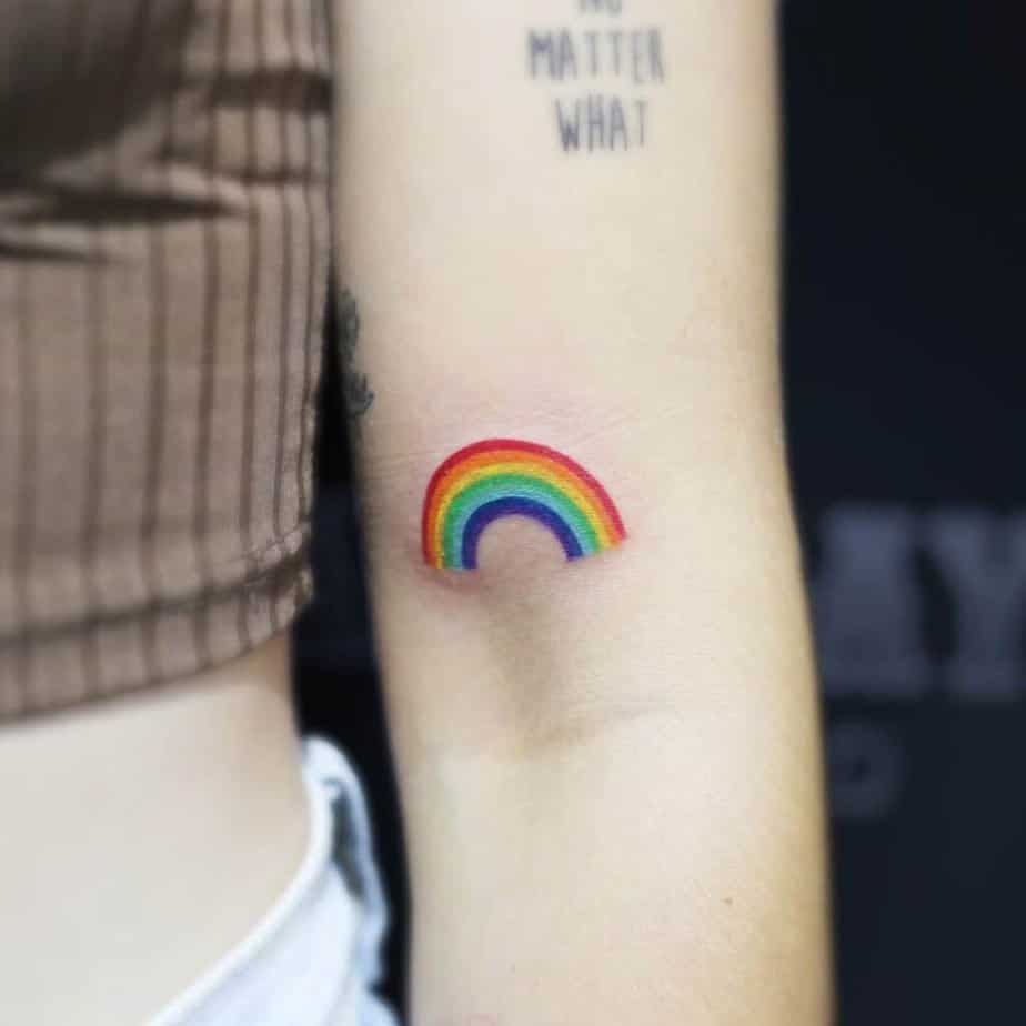 13. A tattoo of a rainbow on the bicep