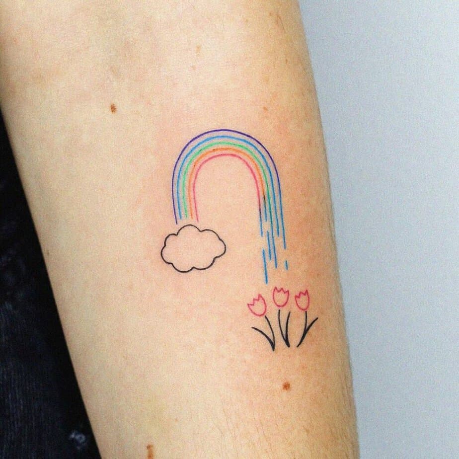 15. A flash tattoo of a rainbow on the arm