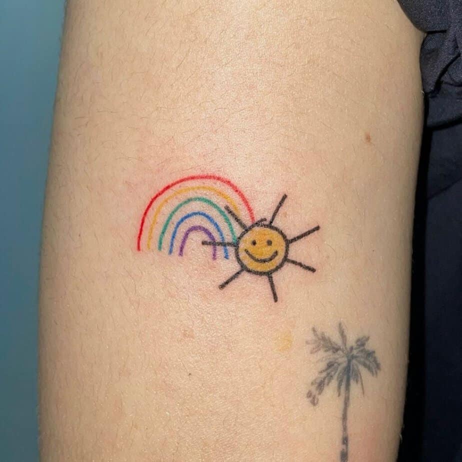 17. A tattoo of a rainbow with a smiley sun