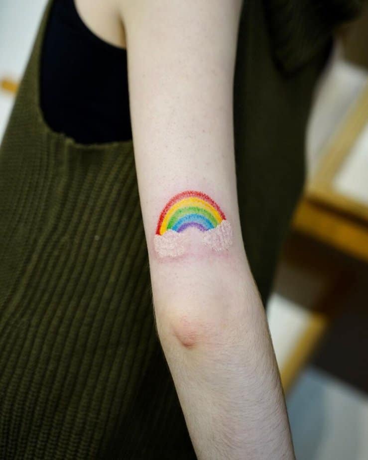 6. A tattoo of a rainbow with clouds