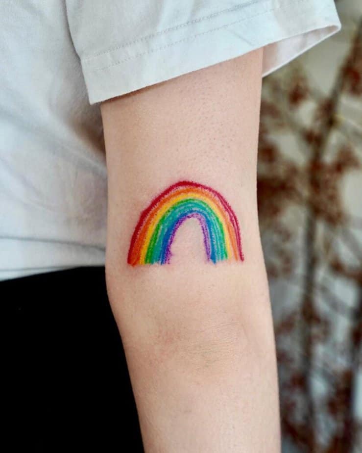 7. A crayon tattoo of a rainbow on the back of the arm