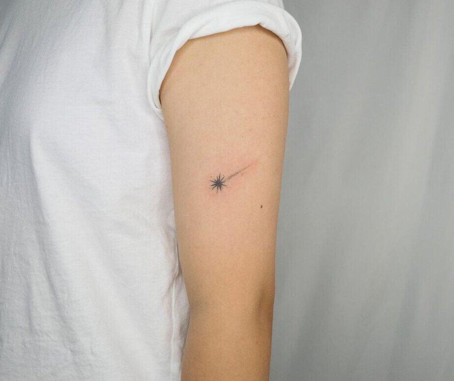 12. A tiny shooting star tattoo