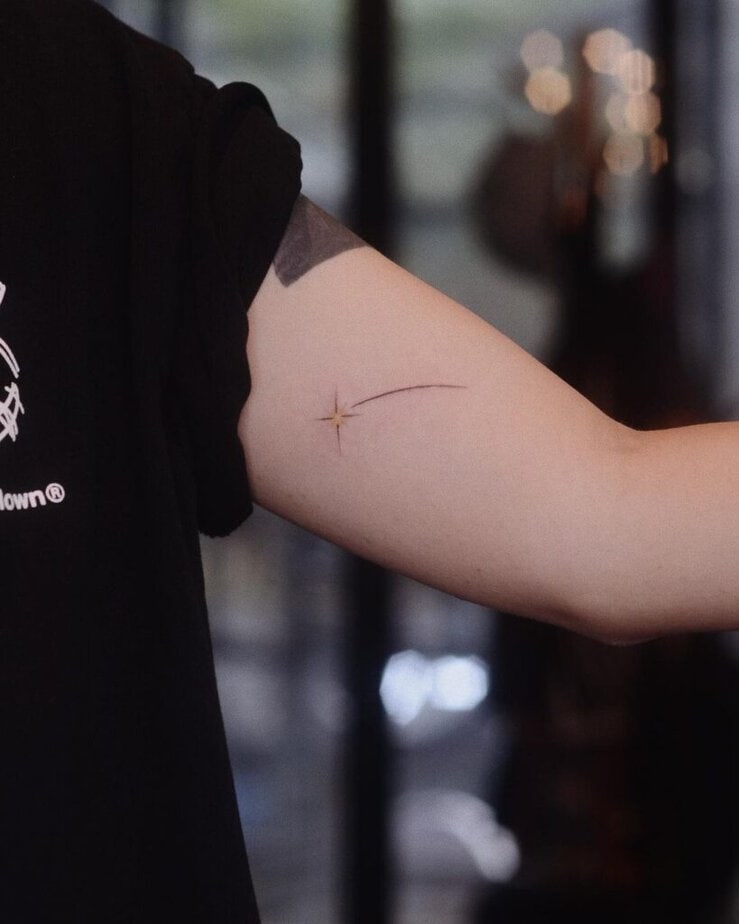 2. A shooting star tattoo on the inside of the arm