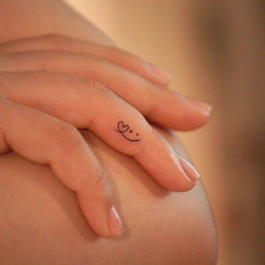 14. A tattoo of a heart with a smiley face
