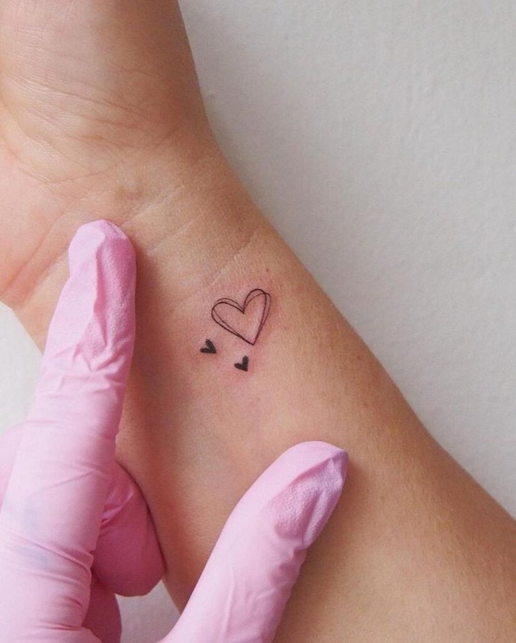 18. A subtle and sleek heart hand tattoo