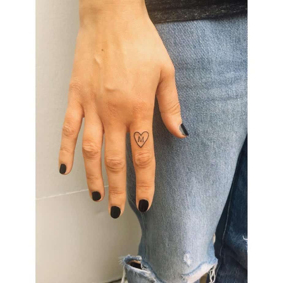 19. A monogrammed heart hand tattoo