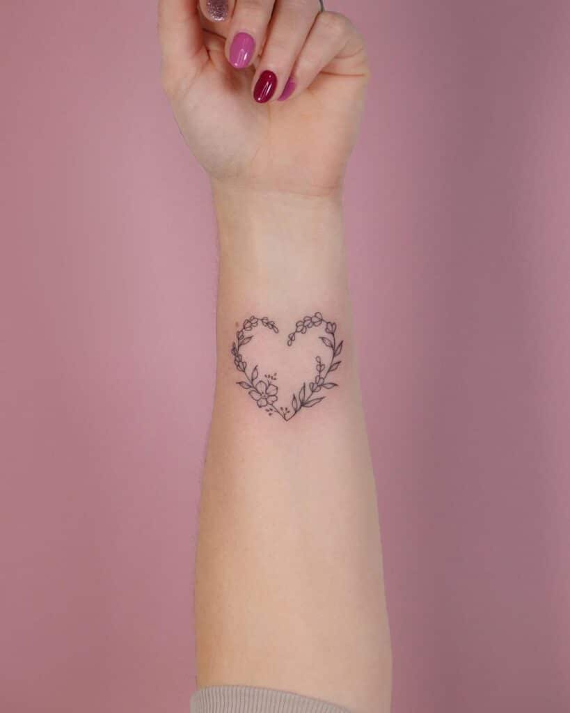 20. A floral heart hand tattoo