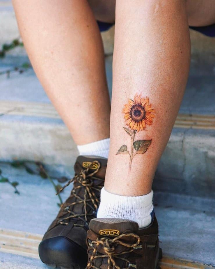 10. A sunflower tattoo on the leg