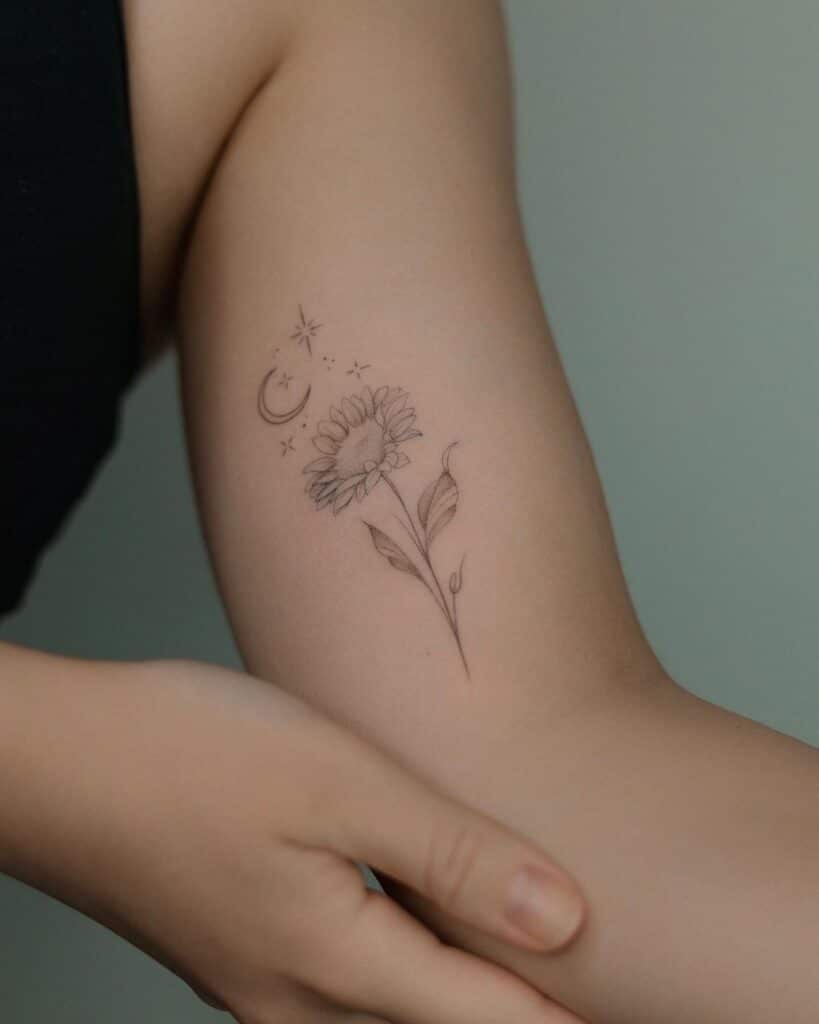 13. A delicate and dainty sunflower tattoo 
