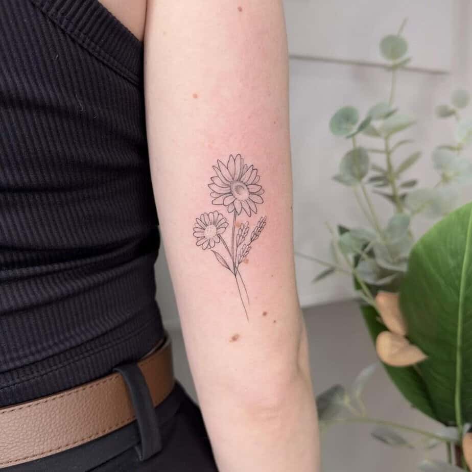 14. A fine-line sunflower tattoo