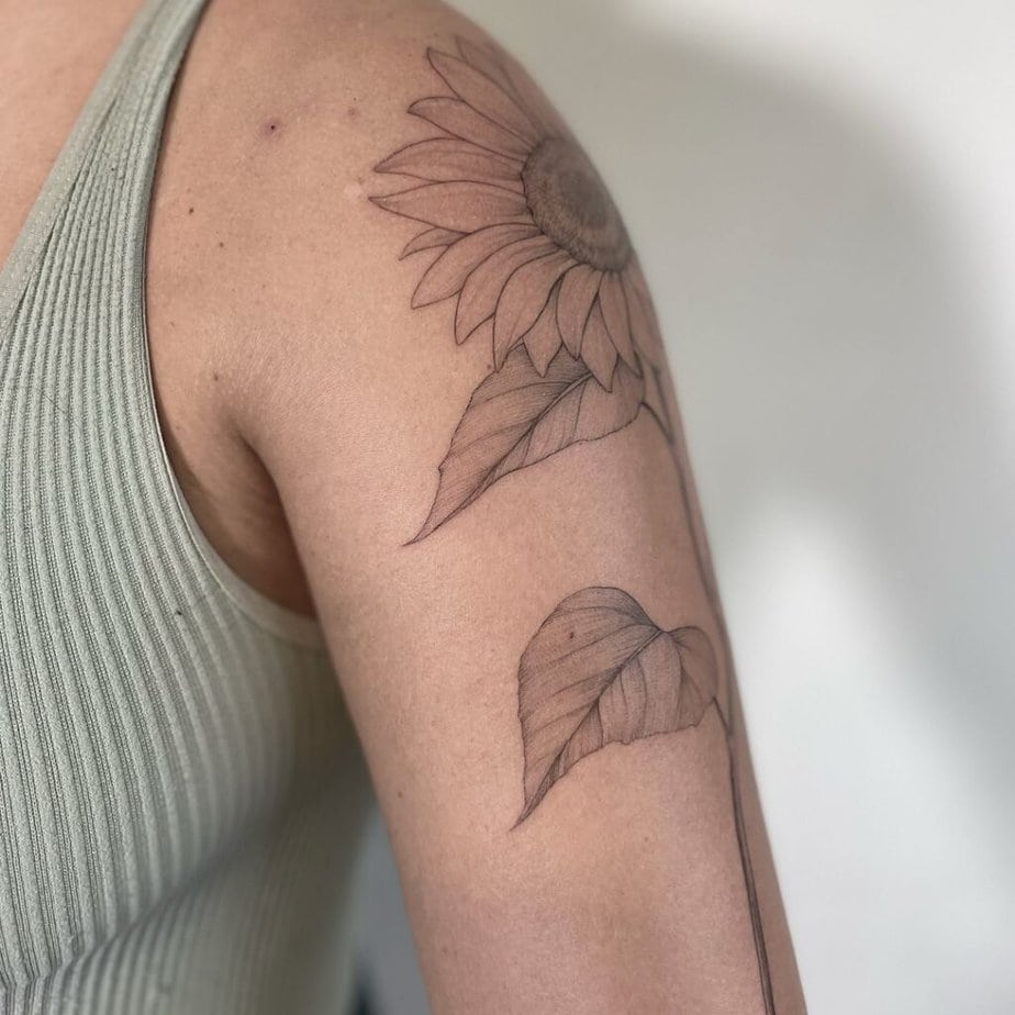 6. A sunflower tattoo on the upper arm