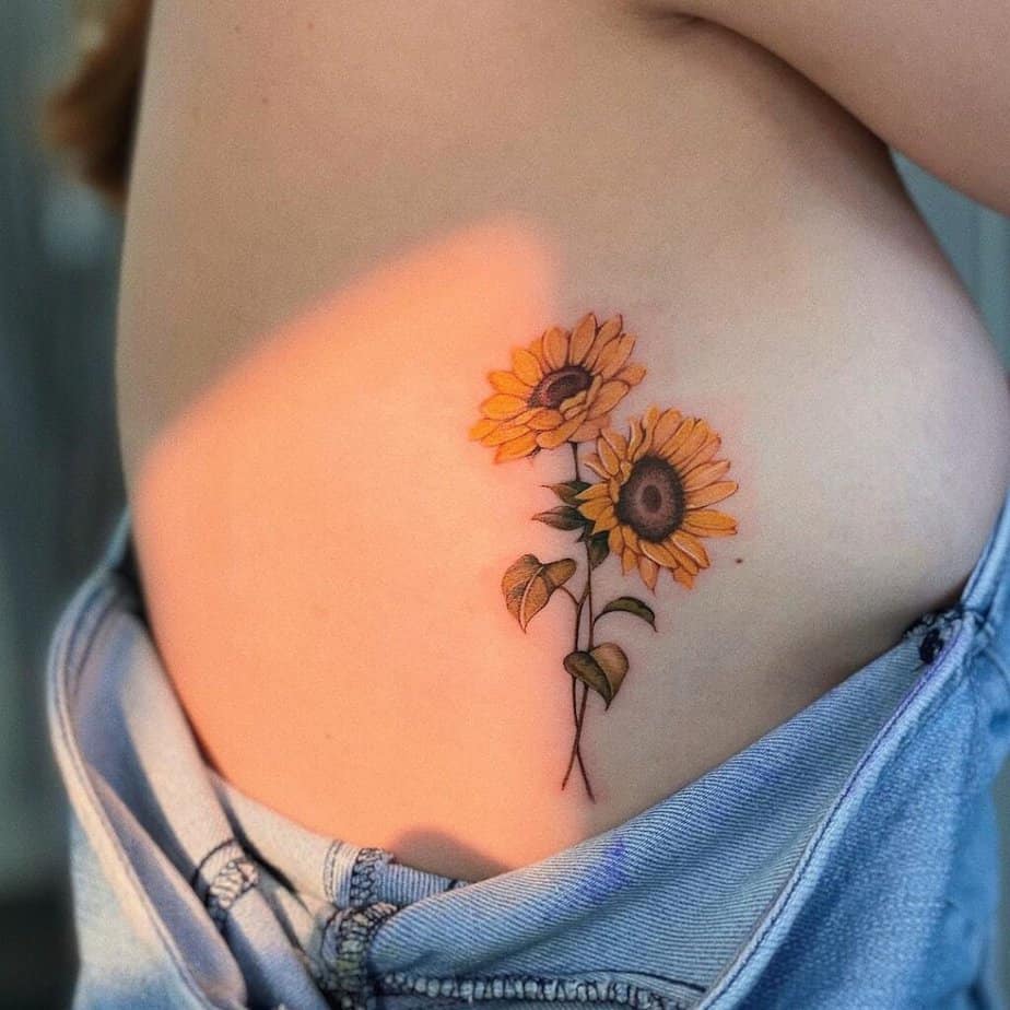 8. A classic sunflower tattoo on the ribcage