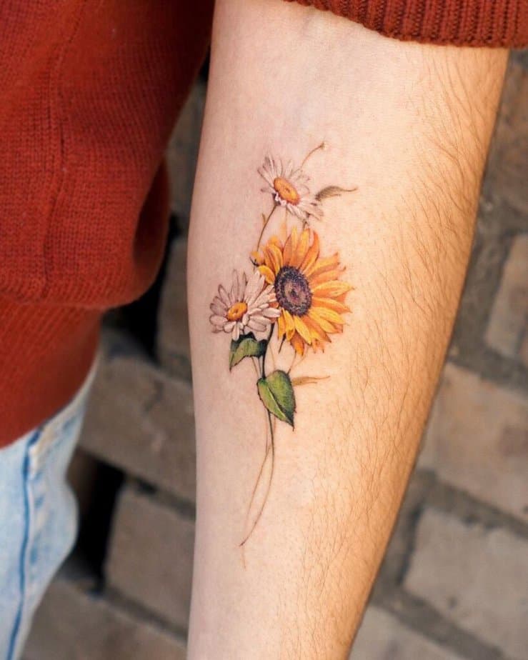 9. A daisy and sunflower bouquet tattoo