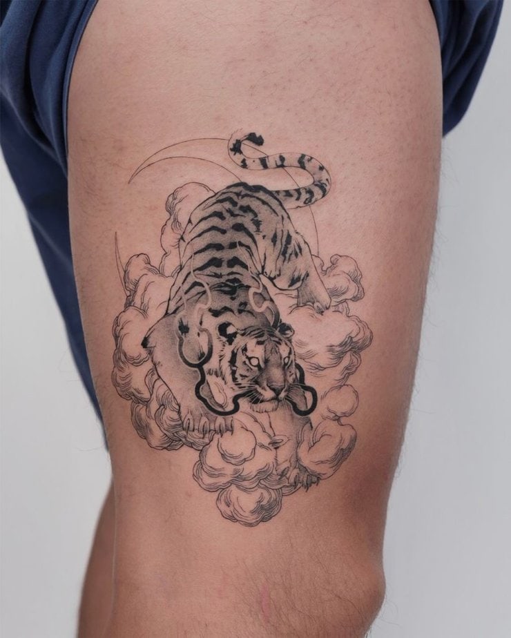 14. A tattoo of a tiger surrounded by clouds 