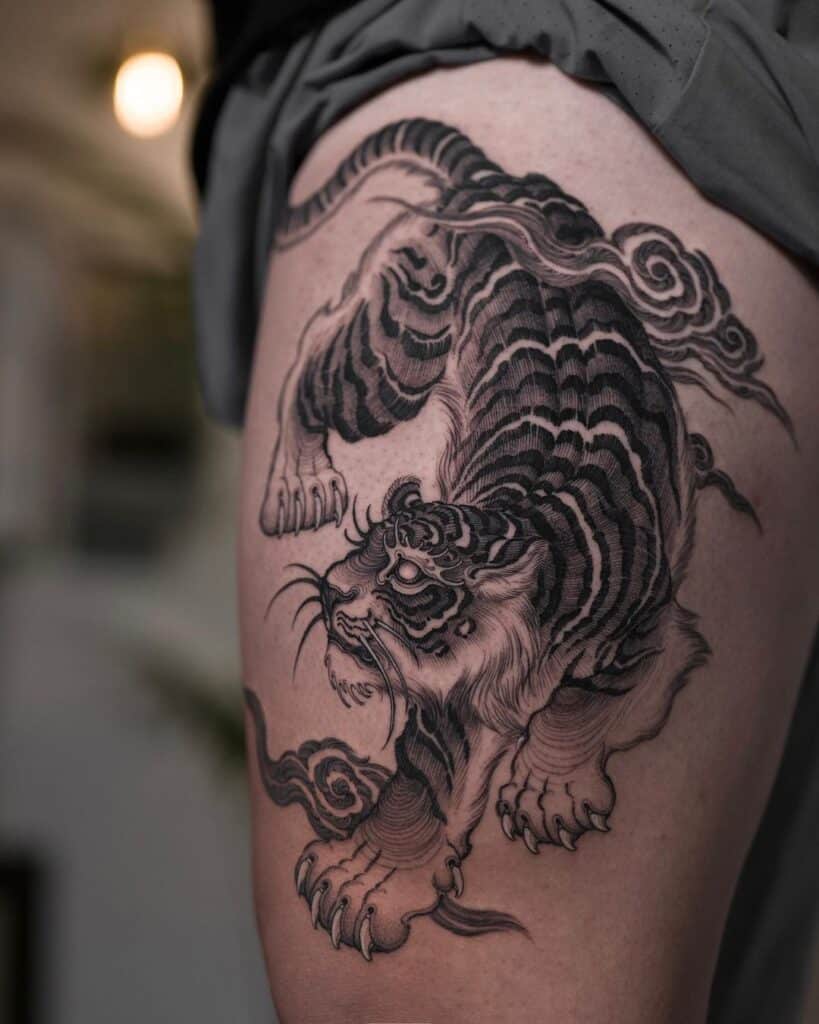 15. Another tattoo of a tiger surrounded by clouds 