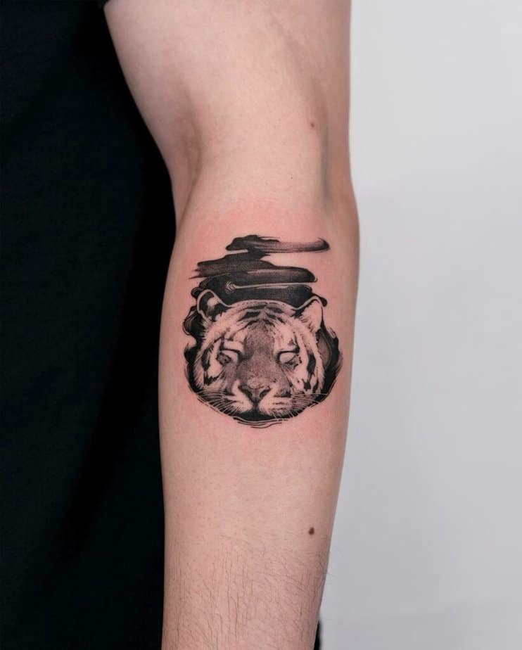 17. A sleepy tiger on the forearm