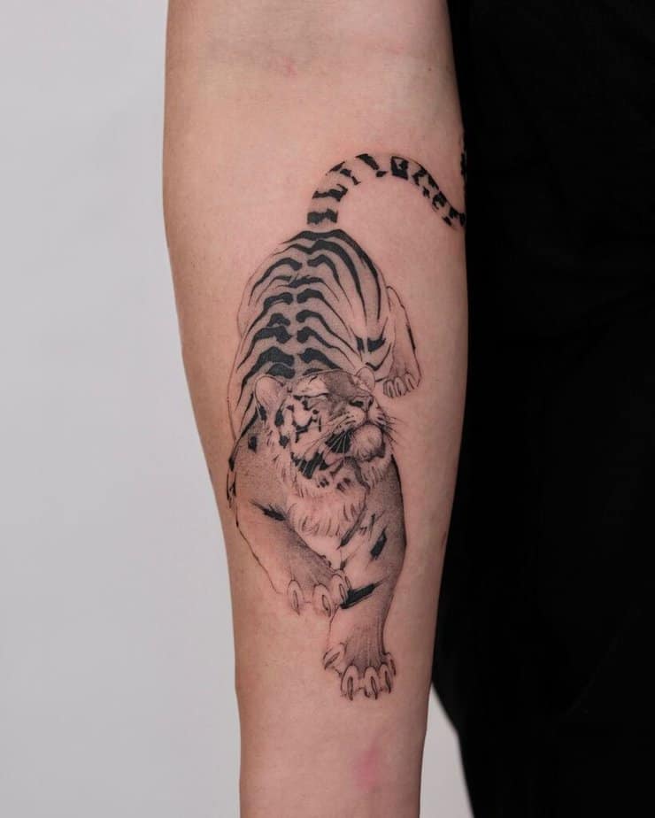 3. A cute and cuddly tiger on the forearm