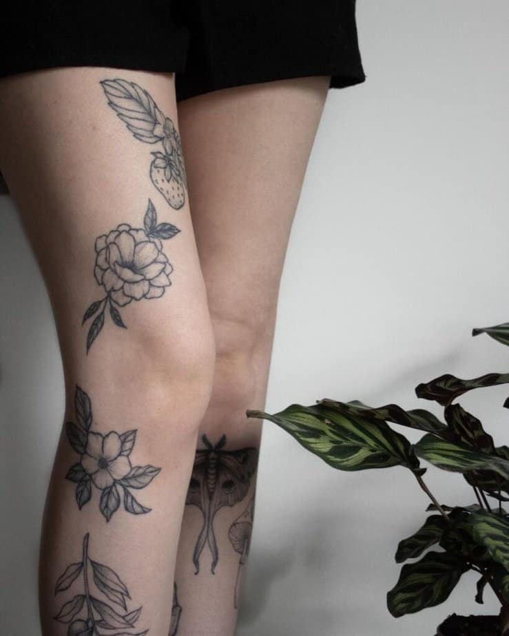 Floral above-knee tattoo