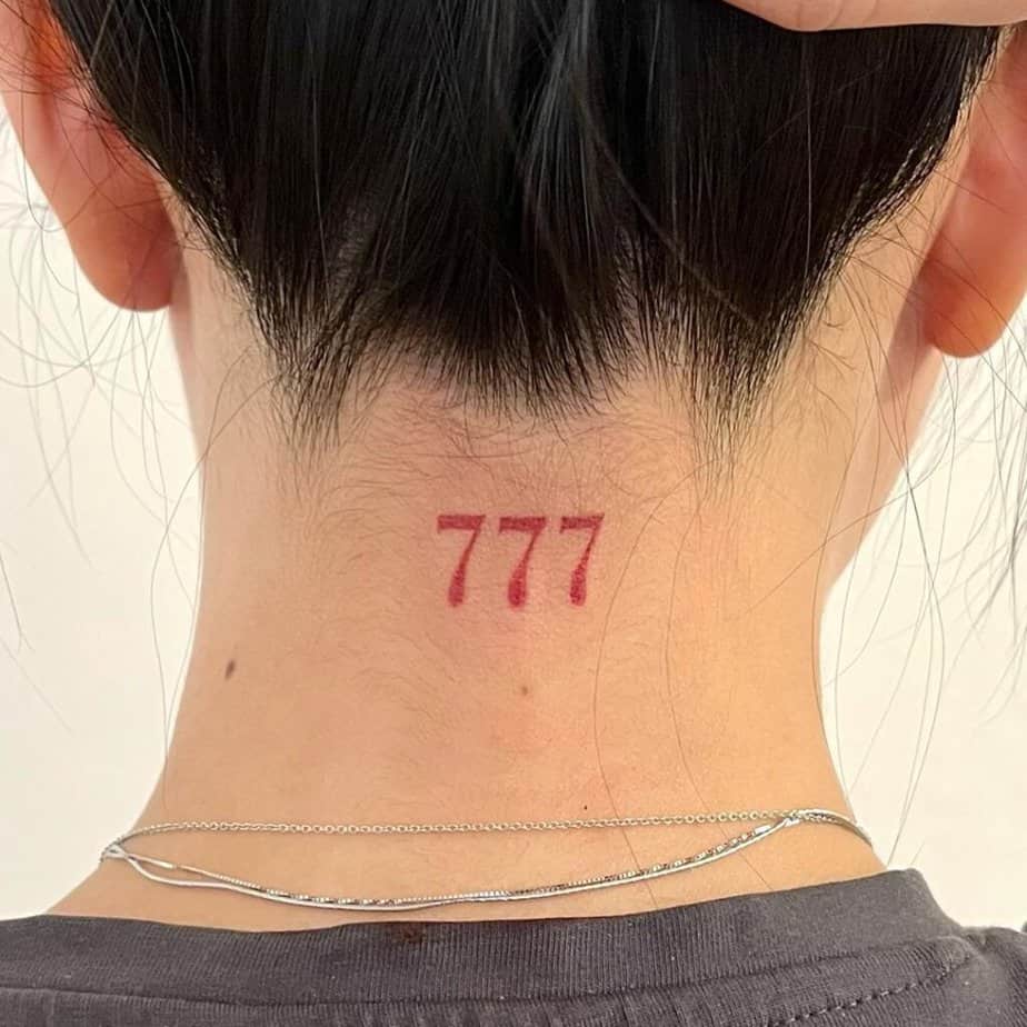 10. A tattoo of angel number 777 on the back of the neck