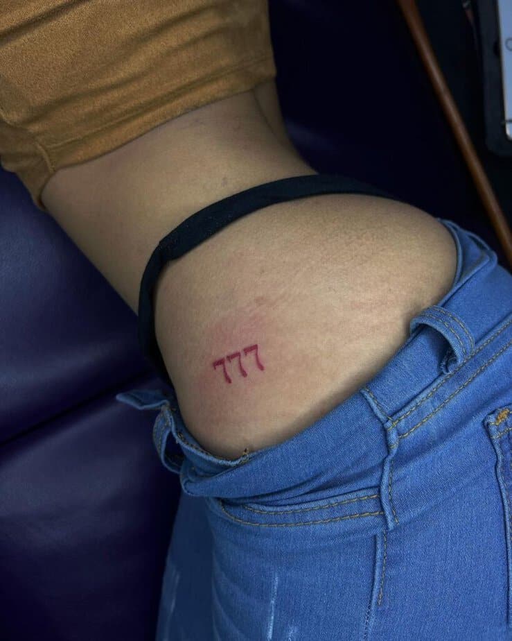 11. A 777 tattoo on the hip 
