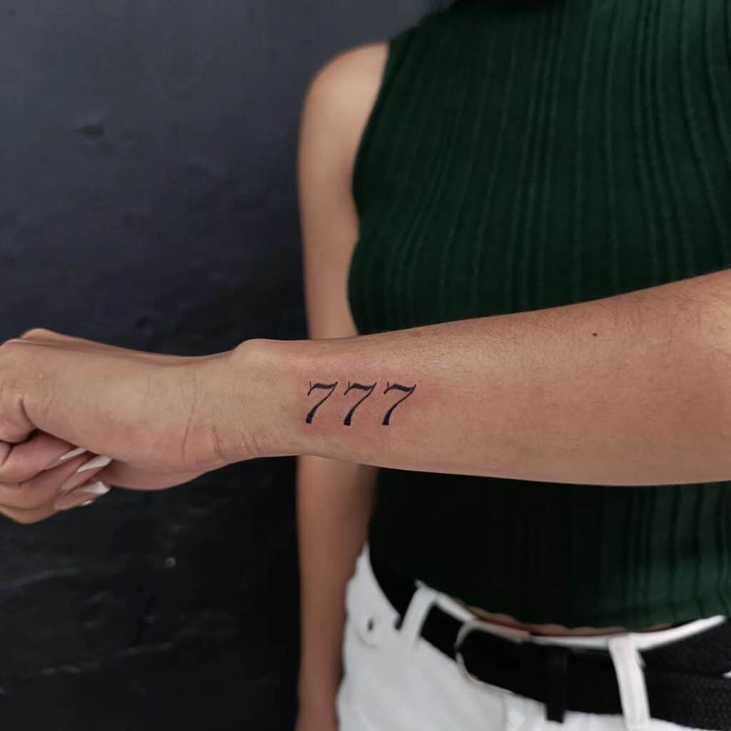15. A 777 tattoo on the side of the wrist